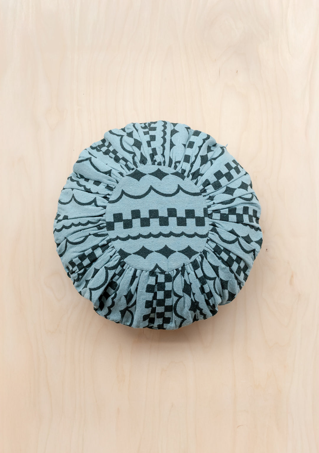 Round Cotton Cushion Cover in Green Checker Stripe by TBCo with a woven black geometric pattern on blue background