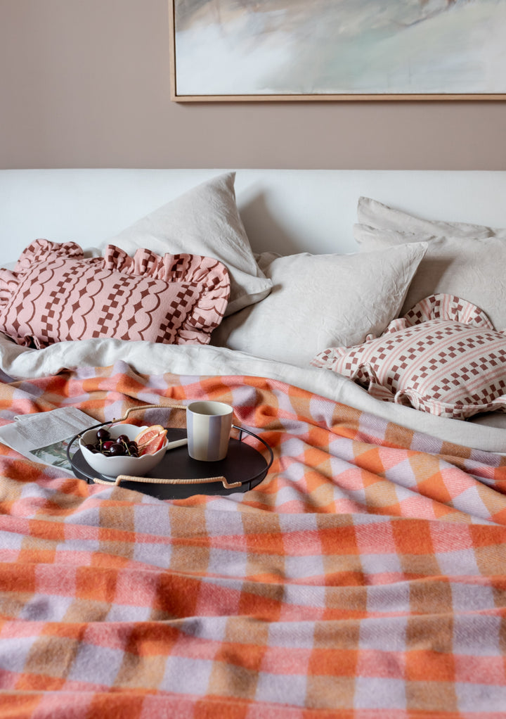 TBCo Cotton Cushion Cover in Pink Stripe styled on bed with matching blanket, decorative ruffled edges and breakfast tray