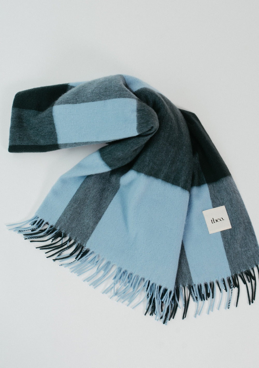 TBCo Lambswool Blanket in Green Modern Check with fringed edges, showcasing soft, warm natural wool for elegant comfort.