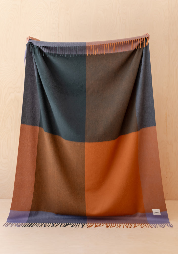 TBCo Lambswool Blanket in Copper Frame Check with a soft fringed edge, showcasing warm autumnal colours and classic design