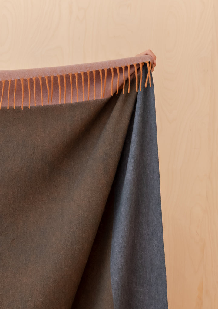 TBCo Lambswool Blanket in Copper Frame Check featuring soft fringed edges and a rich copper lilac colour palette.