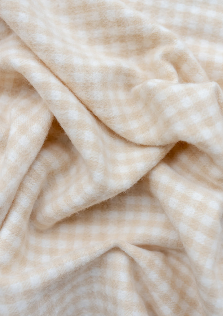 TBCo Lambswool Baby Blanket in Oatmeal Gingham pattern showing soft folds and texture of premium wool fabric