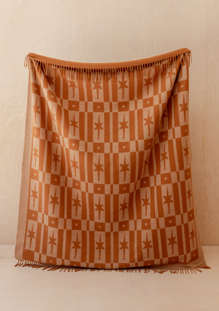 TBCo Lambswool Blanket in Almond Celestial Tile Jacquard with fringed edges, offering warmth and elegant texture