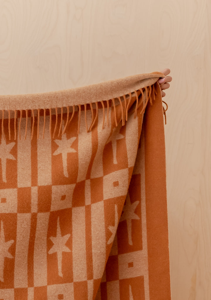 Handheld Lambswool Blanket in Almond Celestial Tile Jacquard by TBCo featuring fringed edges and warm tones
