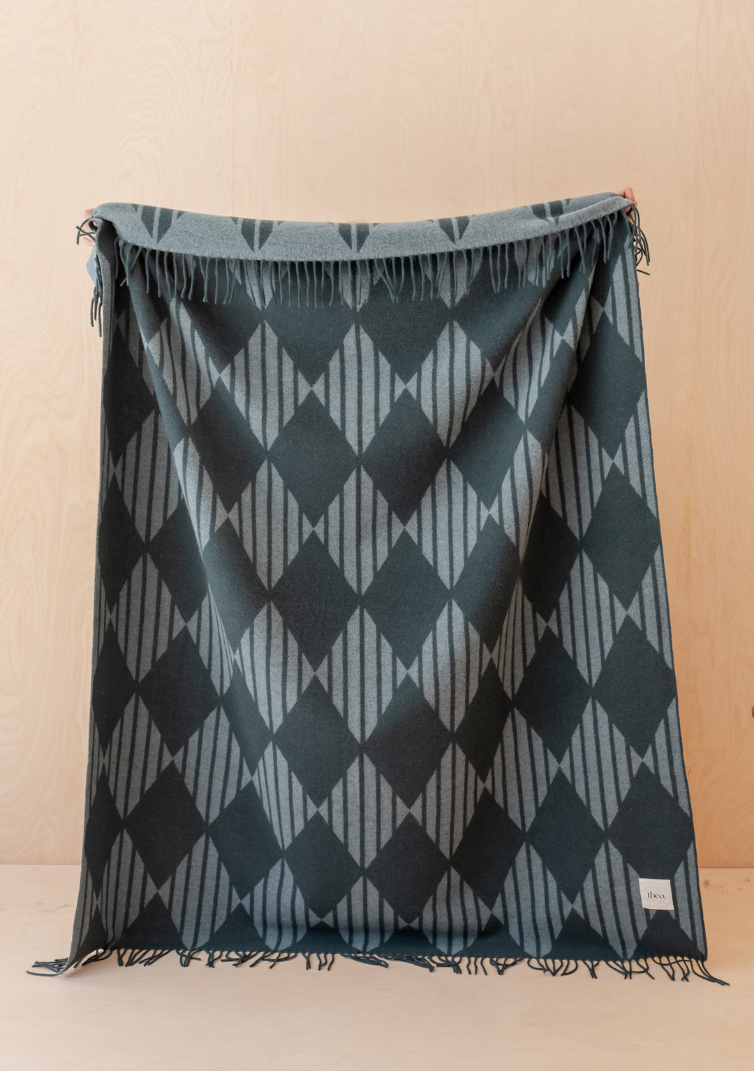 TBCo Lambswool Blanket in Green Stripe Harlequin Jacquard draped with fringed edges and soft texture