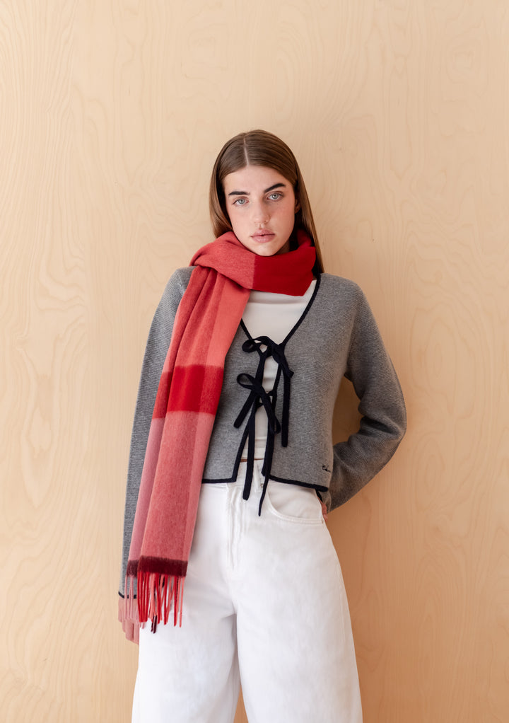 Model wearing TBCo Lambswool Oversized Scarf in Berry Block Check with shades of berry pink red and burgundy