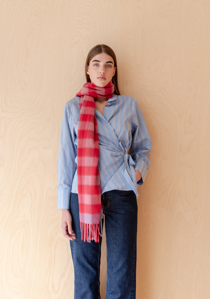 Model wearing a TBCo Lambswool Oversized Scarf in Rose Gingham styled with striped blouse and dark jeans