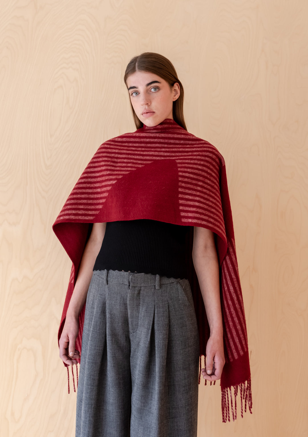 Model wearing TBCo Lambswool Oversized Scarf in Burgundy Wave with fringed edges and striped pattern