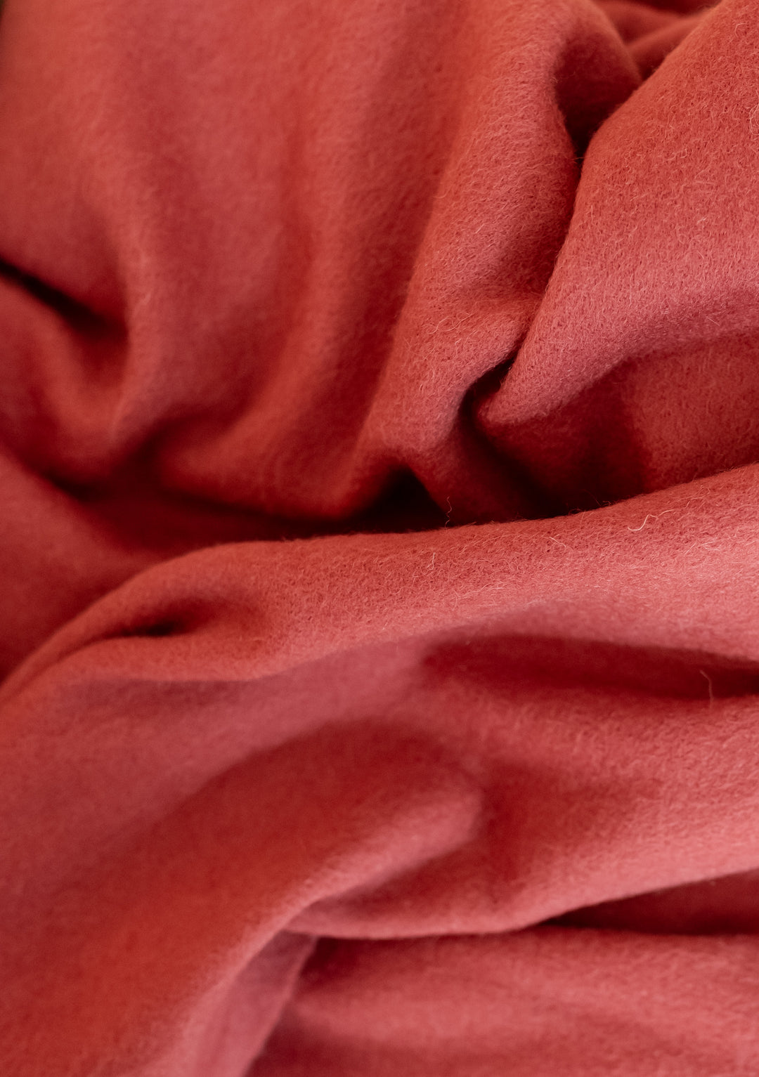 Close-up of soft TBCo Lambswool Oversized Scarf in Mulberry showing texture and warmth of natural fibres