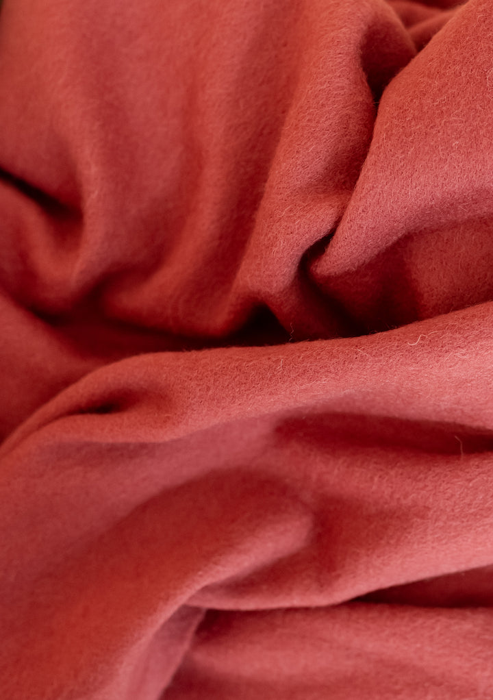 Close-up of soft TBCo Lambswool Oversized Scarf in Mulberry showing texture and warmth of natural fibres