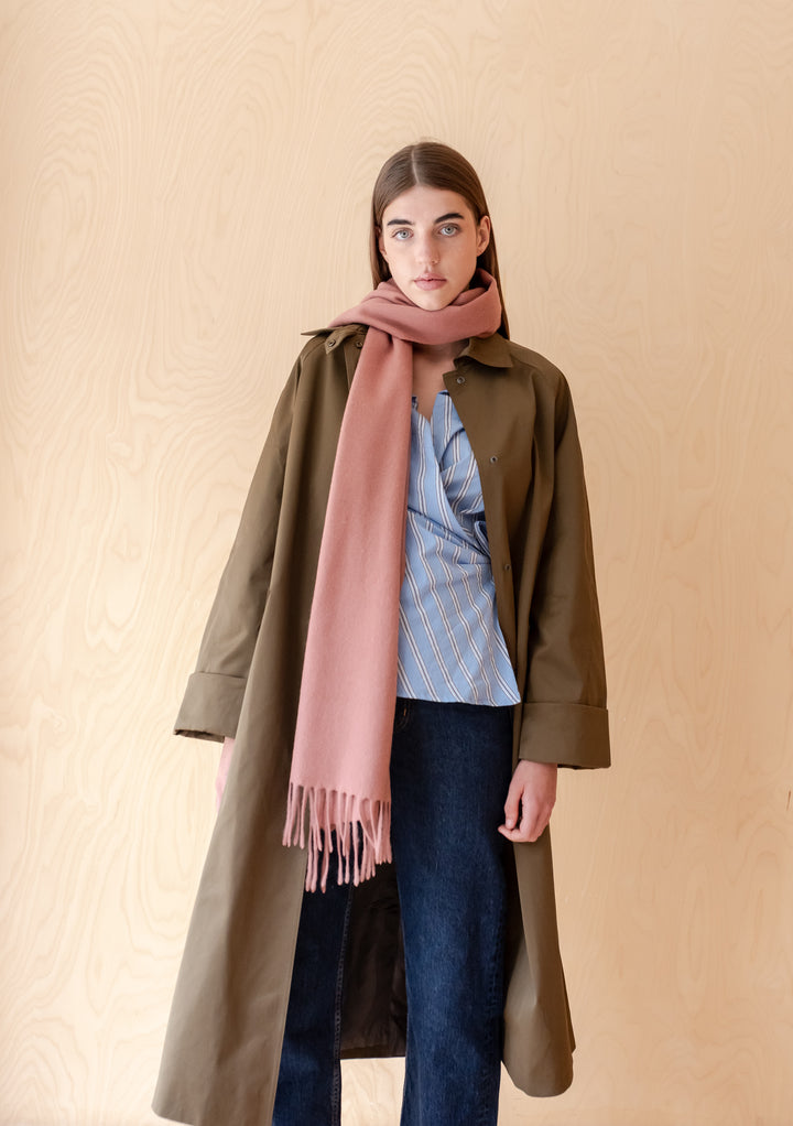 Woman wearing TBCo Lambswool Oversized Scarf in Blush styled with a coat and casual outfit against neutral background