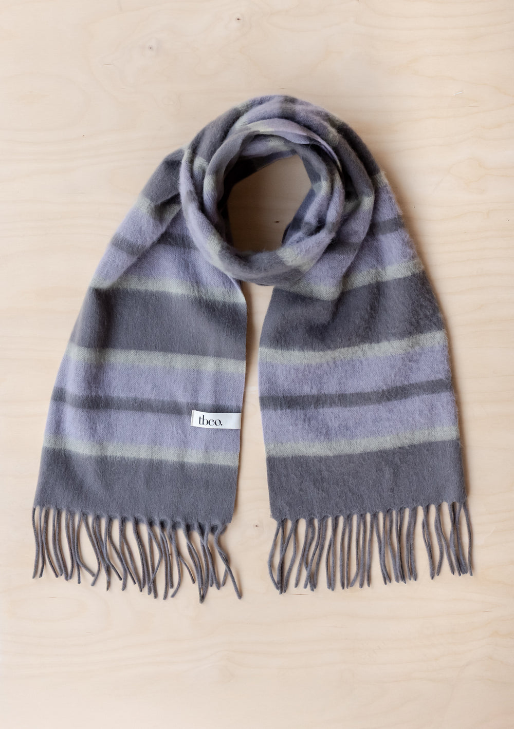 Lambswool Oversized Scarf in Charcoal Stripe by TBCo showing soft fringed lambswool fabric with charcoal and lilac stripes