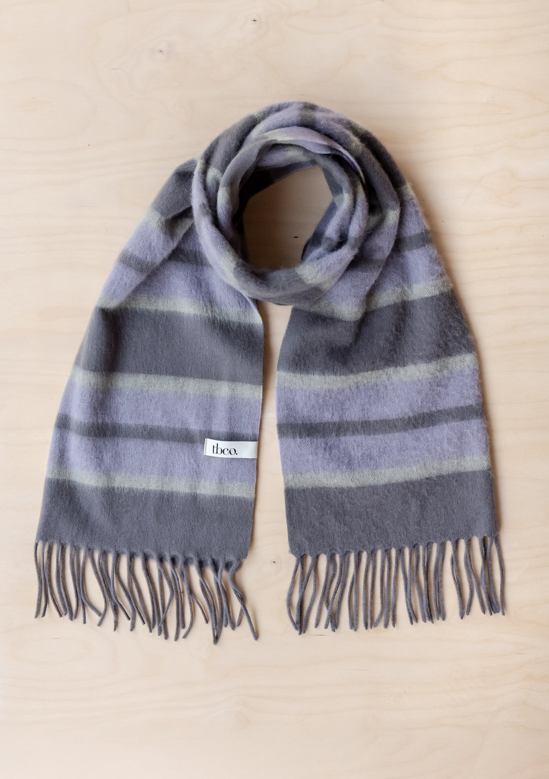 Lambswool Oversized Scarf in Charcoal Stripe by TBCo showing soft fringed lambswool fabric with charcoal and lilac stripes