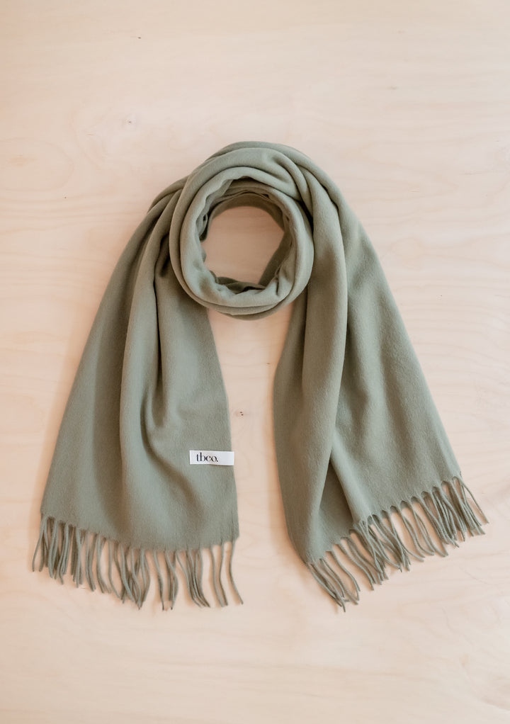 Soft Lambswool Blanket Scarf in Olive by TBCo with fringed edge, perfect for warmth and style.