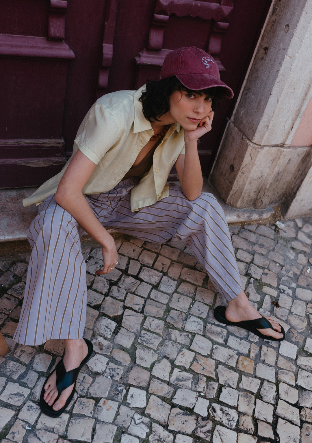 Relaxed lifestyle shot of TBCo Cotton Trousers in Lilac Stripe, featuring casual striped design and comfortable fit