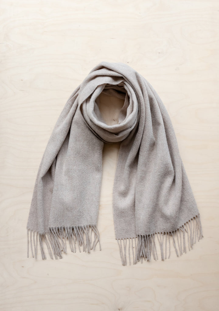 TBCo Lambswool Blanket Scarf in Oatmeal Melange with fringed edges, elegantly draped to showcase soft texture and natural colour