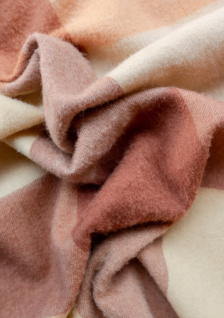 TBCo lambswool oversized scarf in buttermilk and brown block check pattern, showing soft textured wool fabric folds