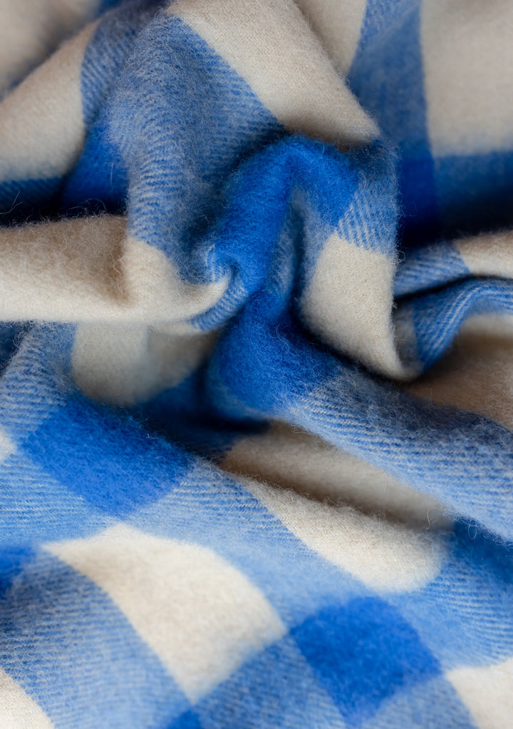 TBCo Lambswool Oversized Scarf in Blue Check showcasing soft, textured fabric with blue and cream checkered pattern detail