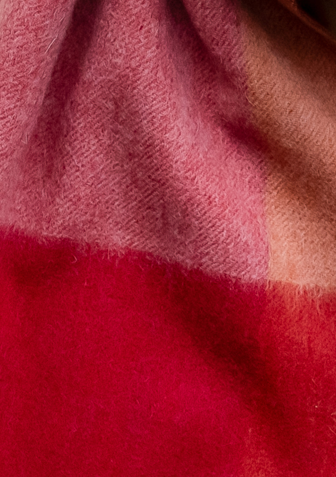 Close-up texture view of TBCo Lambswool Oversized Scarf in Berry Edge Check showing pink and deep red wool pattern details