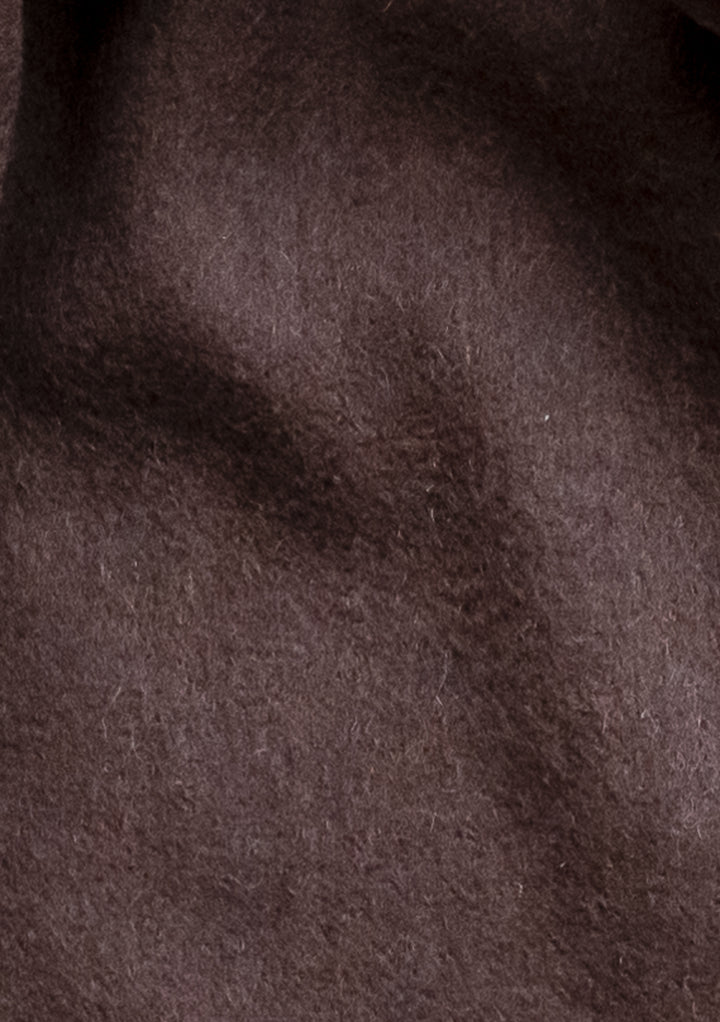 Close-up texture of TBCo Lambswool Oversized Scarf in Chocolate showing rich brown wool fabric with soft, luxurious finish