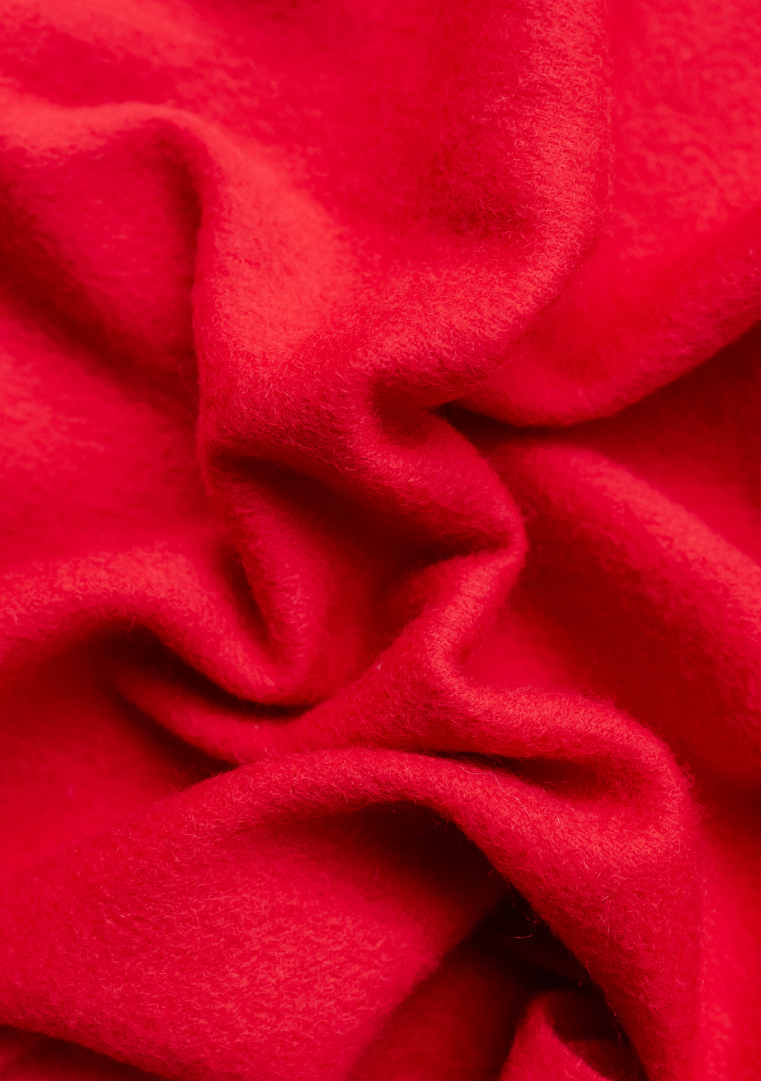 Close-up texture of TBCo's Lambswool Oversized Scarf in Red showing soft, draped fabric with natural wool texture