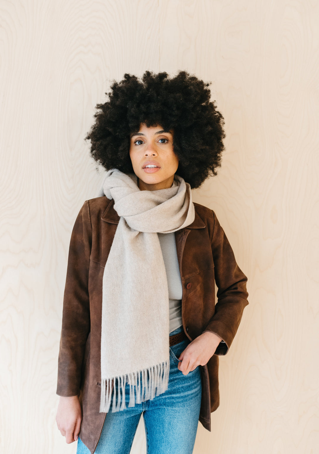 TBCo Lambswool Oversized Scarf in Oatmeal Melange styled casually with brown jacket and denim, showing fringed detail