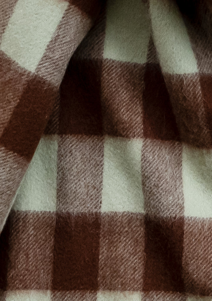 Close-up detail of TBCo Lambswool Blanket Scarf in Green Gingham showing mint green and chocolate brown check pattern