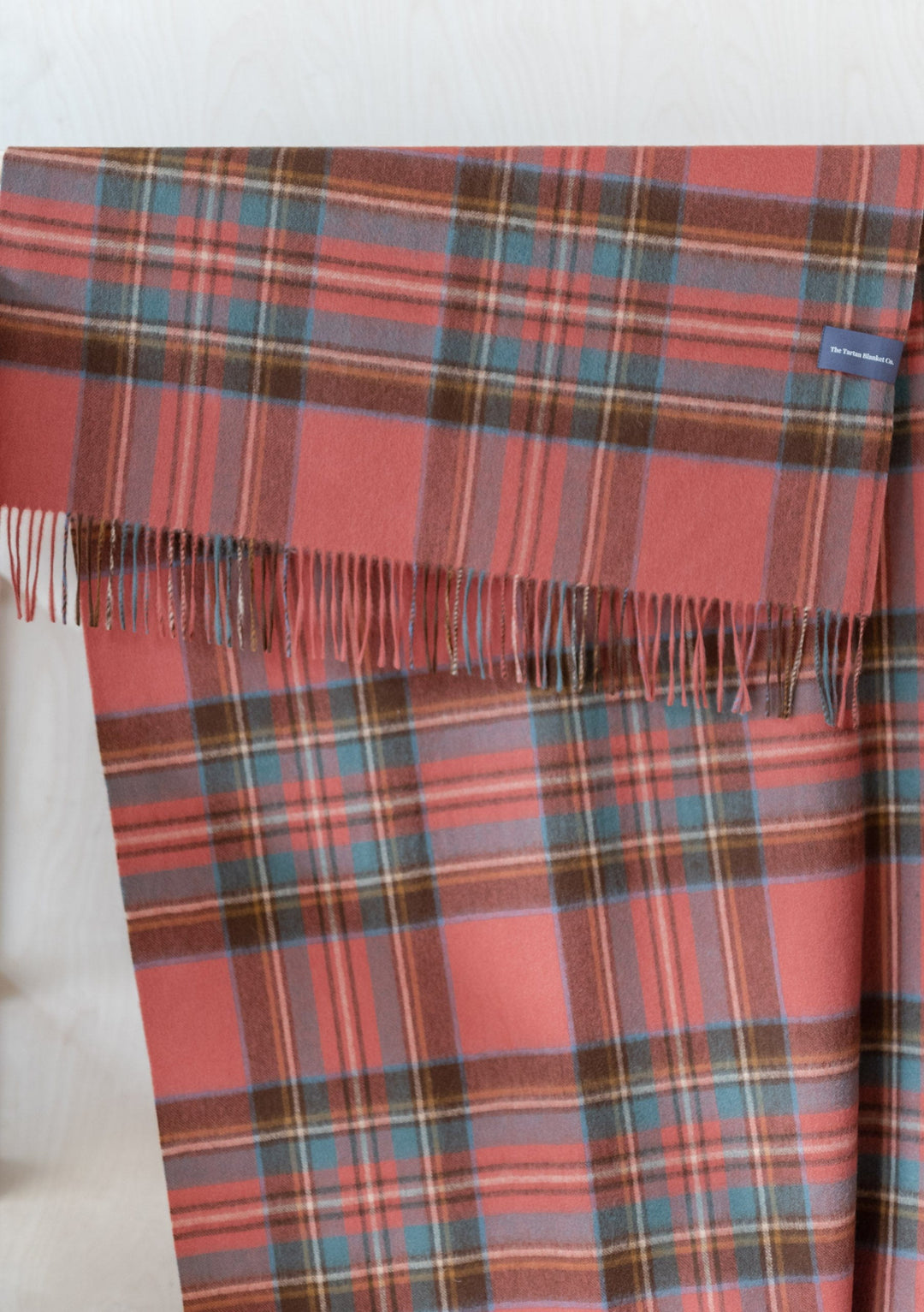 TBCo Lambswool Blanket Scarf in Stewart Royal Antique Tartan featuring coral pink and blue plaid pattern with fringed edge