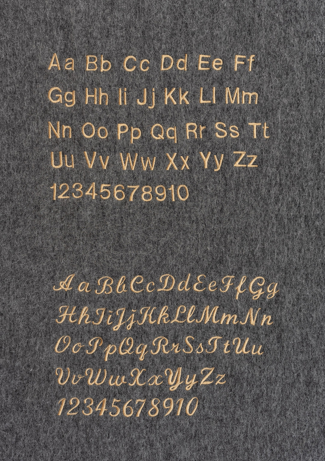 Embroidery font options for personalised Cotton Pyjamas in Lilac Stripe by TBCo displayed on grey fabric.