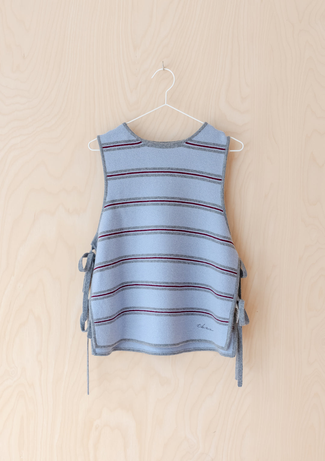 Merino Wool Tie Vest in Blue Stripe by TBCo features breathable merino wool with side tie closures and a casual striped design.