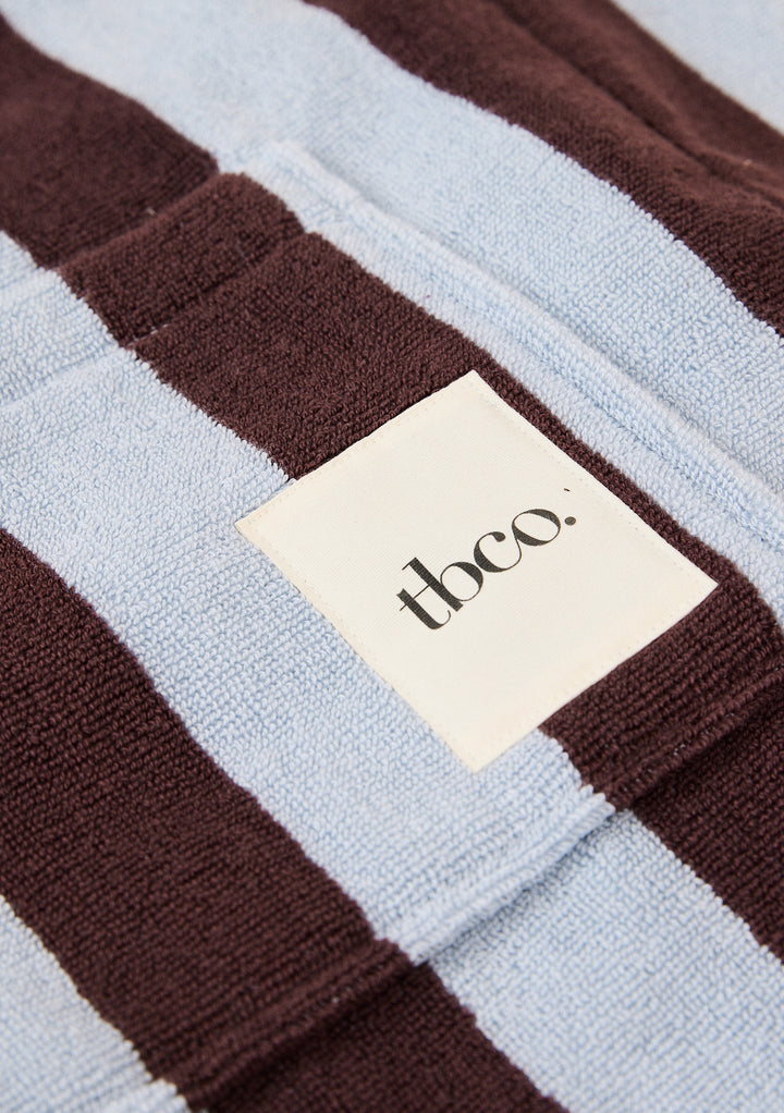Close-up of TBCo label on the soft terry fabric of Terry Cotton Tote Bag in Blue Stripe with textured blue and brown bands