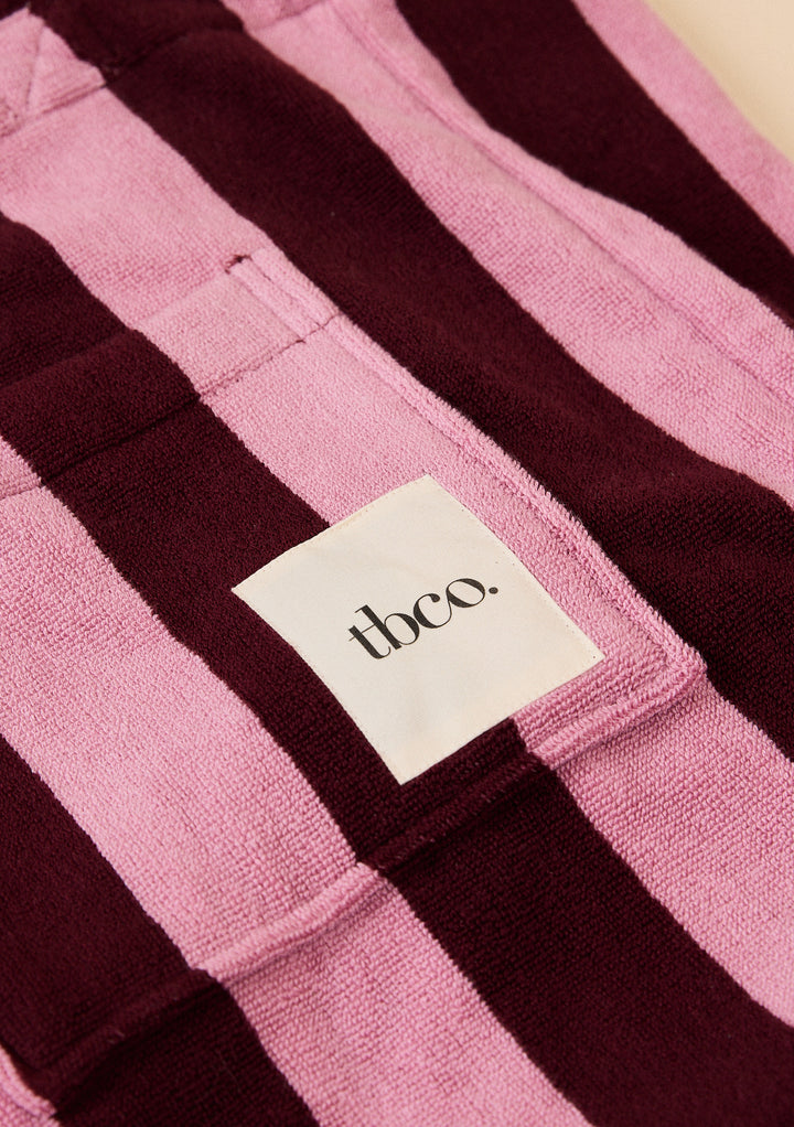Close-up of TBCo label on the soft terry fabric of Terry Cotton Tote Bag in Burgundy Stripe with textured wide stripes and pocket detail