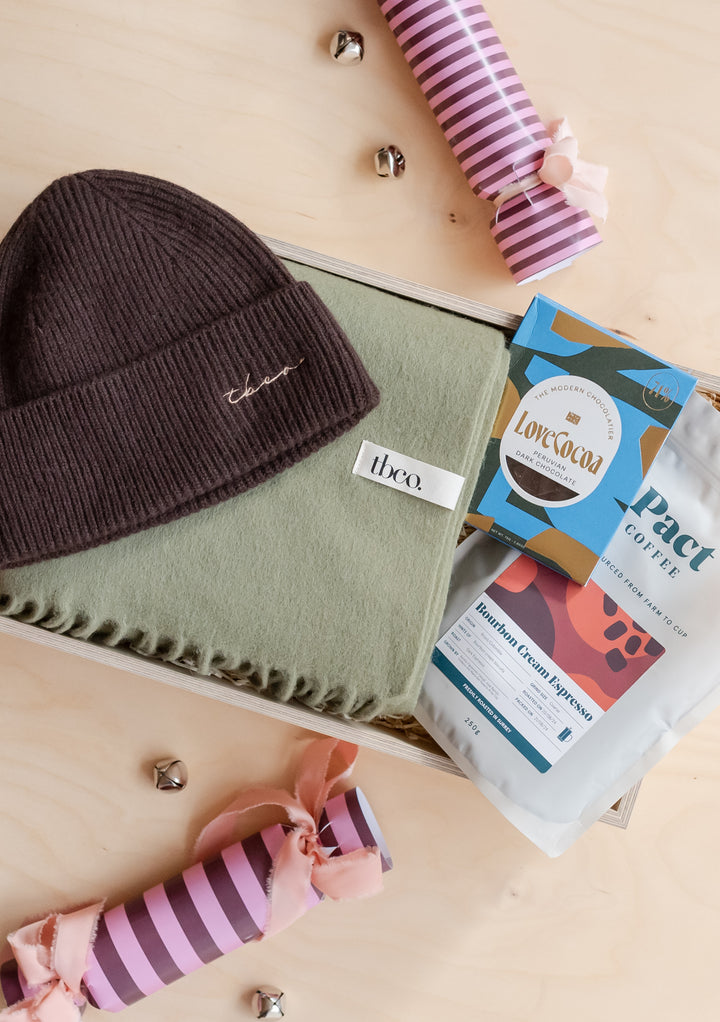 TBCo Gift Box For Him featuring a warm hat, soft scarf, coffee, and chocolate in an elegant presentation box