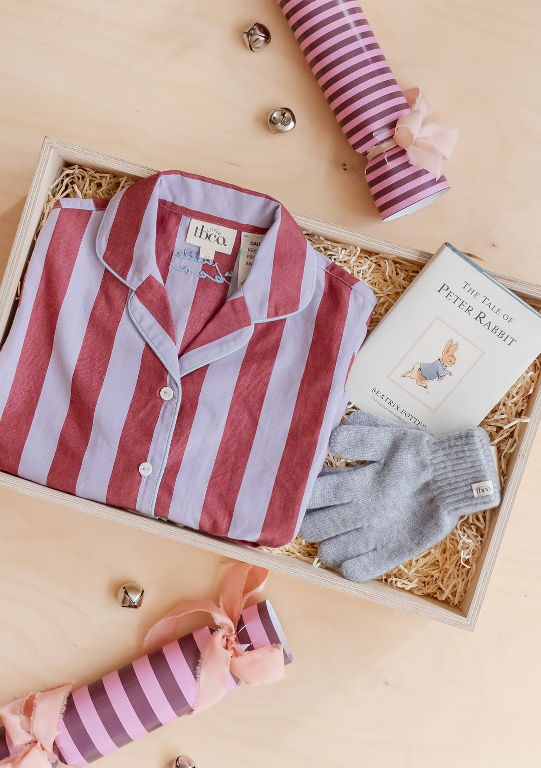 Kids Gift Box by TBCo featuring striped pyjamas, Peter Rabbit book, grey gloves, and festive crackers in a wooden box