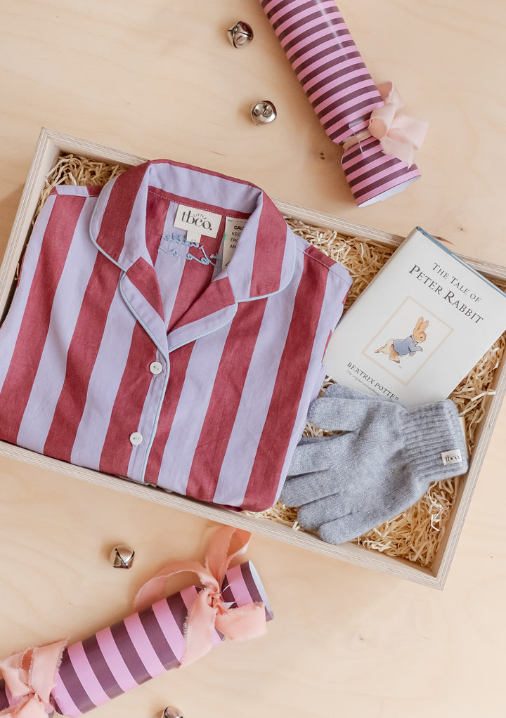 Kids Gift Box by TBCo featuring striped pyjamas, Peter Rabbit book, grey gloves, and festive crackers in a wooden box