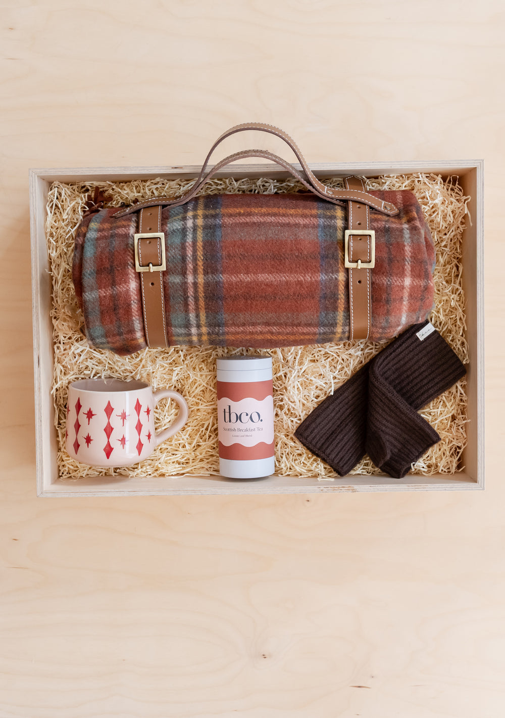 Picnic Gift Box by TBCo featuring a plaid blanket, mug, tea tin, and cosy socks in eco-friendly packaging.