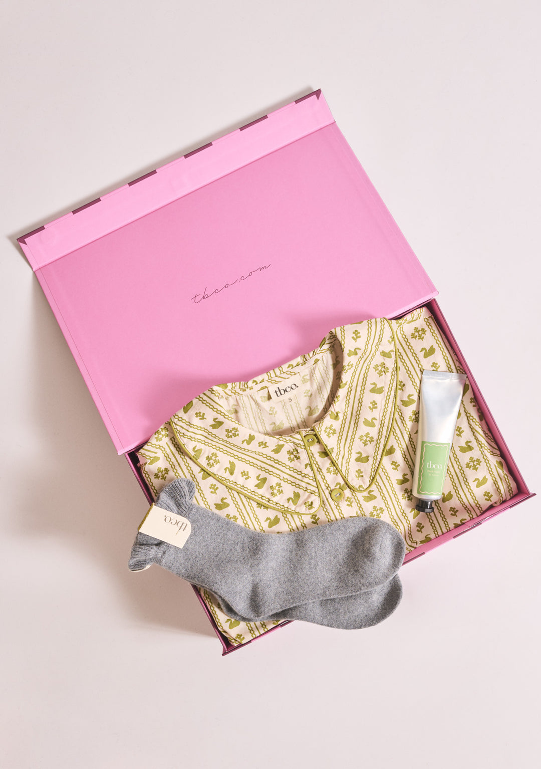 TBCo Mother's Day gift box set with a  pair of socks and hand cream in a pink gift box on a light background