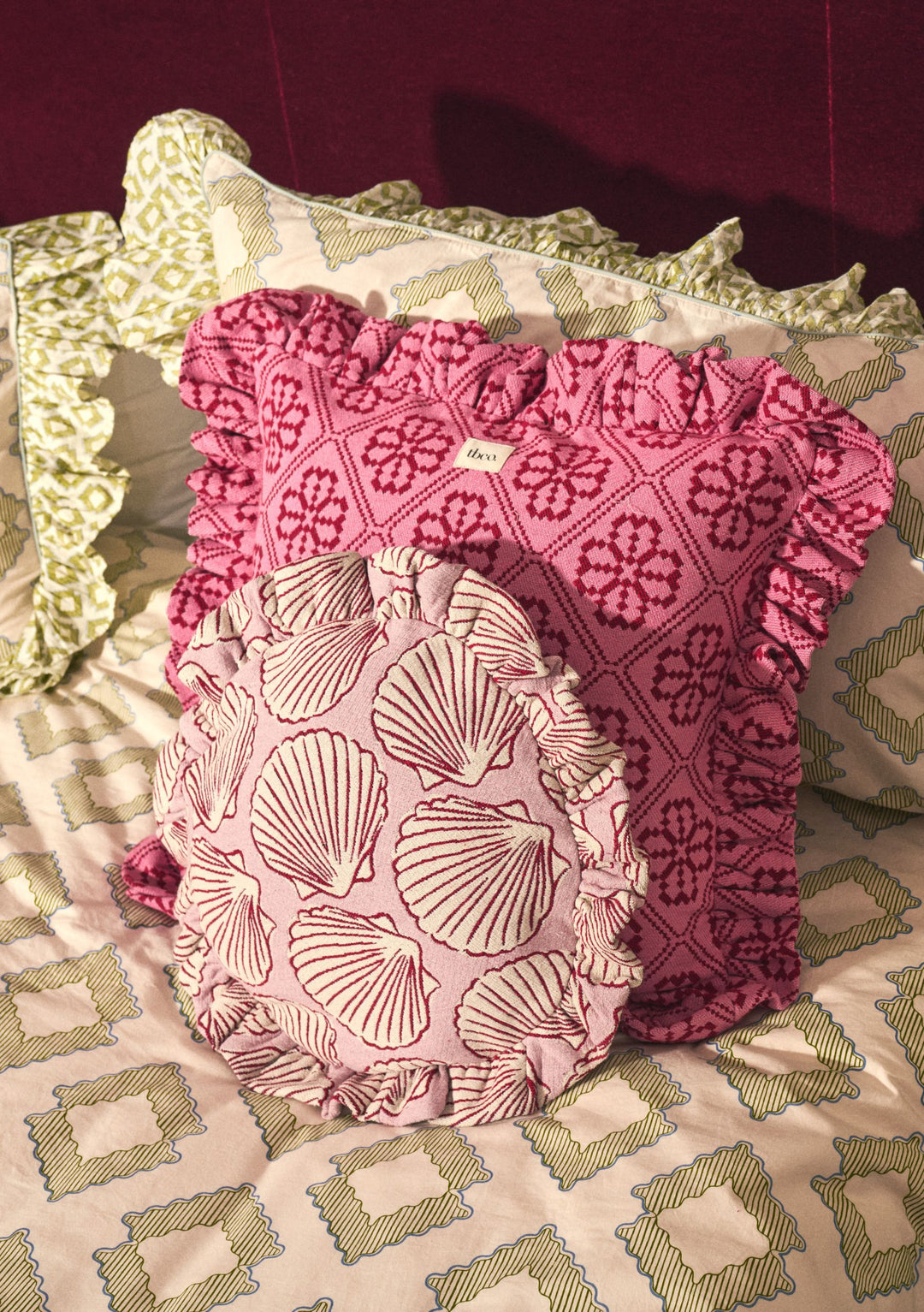 Cotton Cushion Cover in Pink Shell by TBCo featuring ruffled edges and shell pattern on soft pink fabric