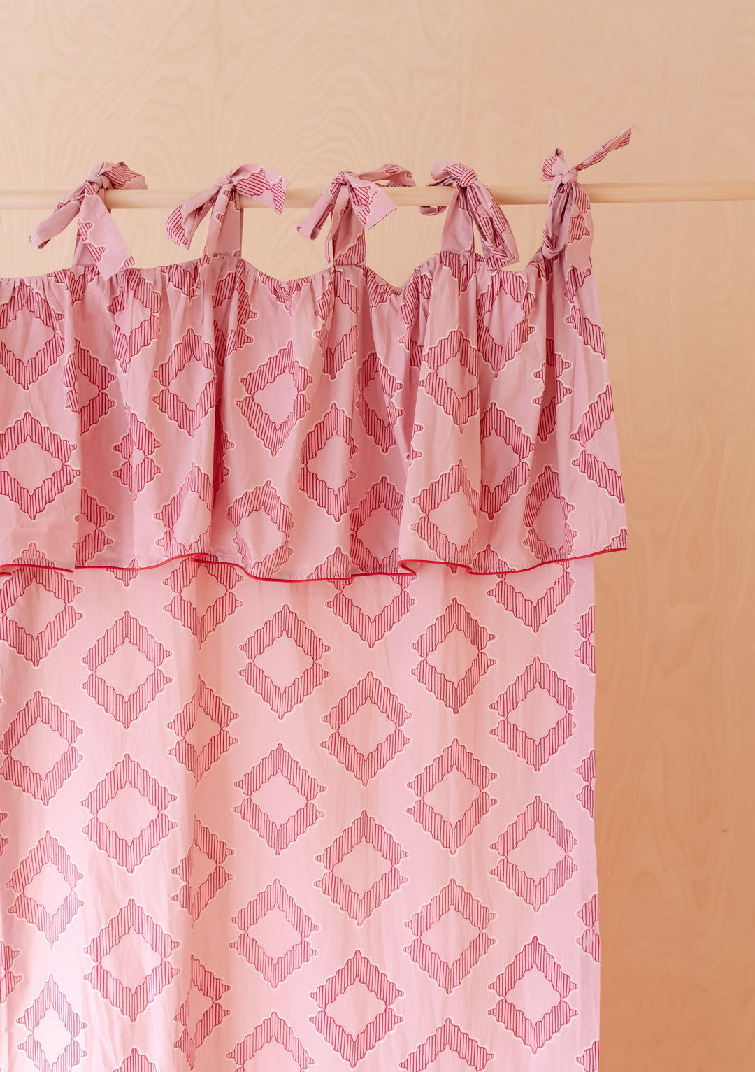 Portrait image of TBCo Pair of Cotton Tie-Top Curtains in Pink Diamond with bow ties in gallery position one