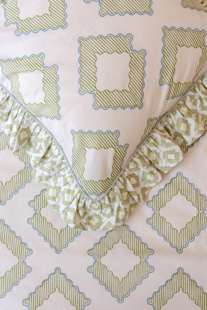 Close-up portrait of TBCo Pair of Cotton Pillowcases in Green Diamond showing ruffled edges and diamond pattern.