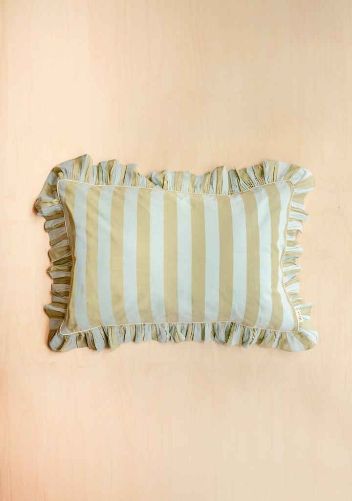Single Pair of Cotton Pillowcases in Mint Stripe by TBCo with ruffled edge on pale wood background