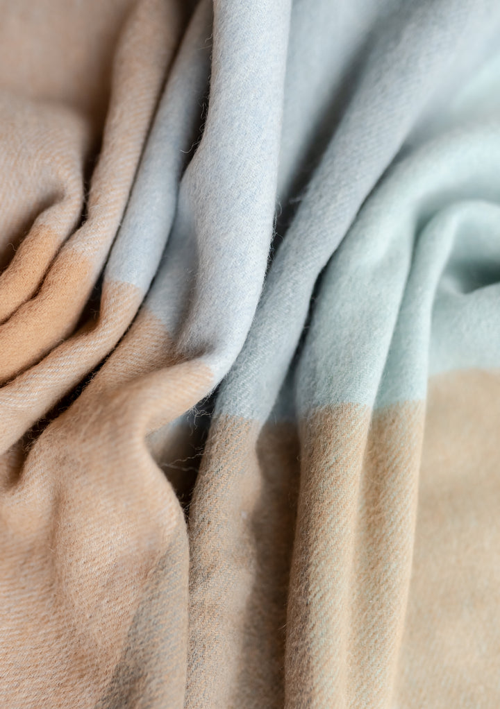 Close-up of folded TBCo Lambswool Baby Blanket in Blue Block Check showing soft texture in gallery position 3 portrait shot
