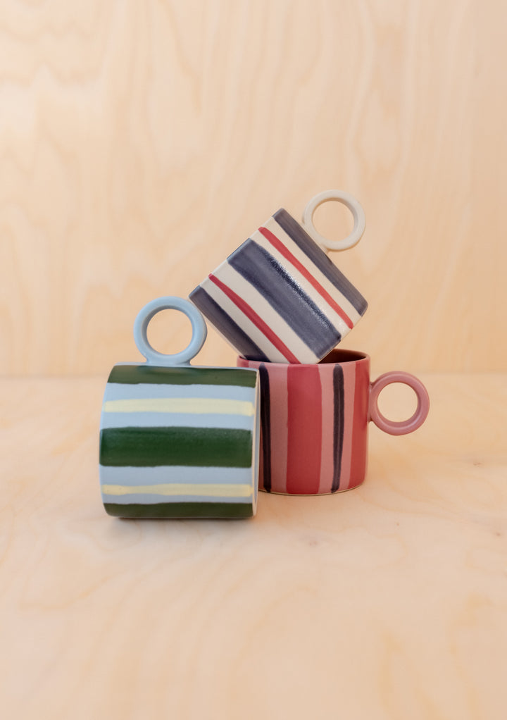 Three Blue Stripe Hand-Painted Mugs by TBCo stacked to display hand-painted colourful stripes on smooth ceramic surface