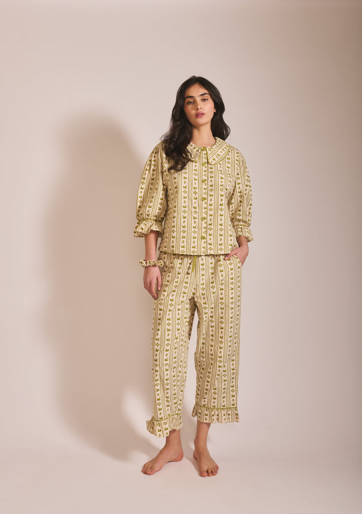 Model wearing TBCo Cropped Cotton Pyjamas in Olive Swan with puff sleeves and ruffle detail on cropped trousers