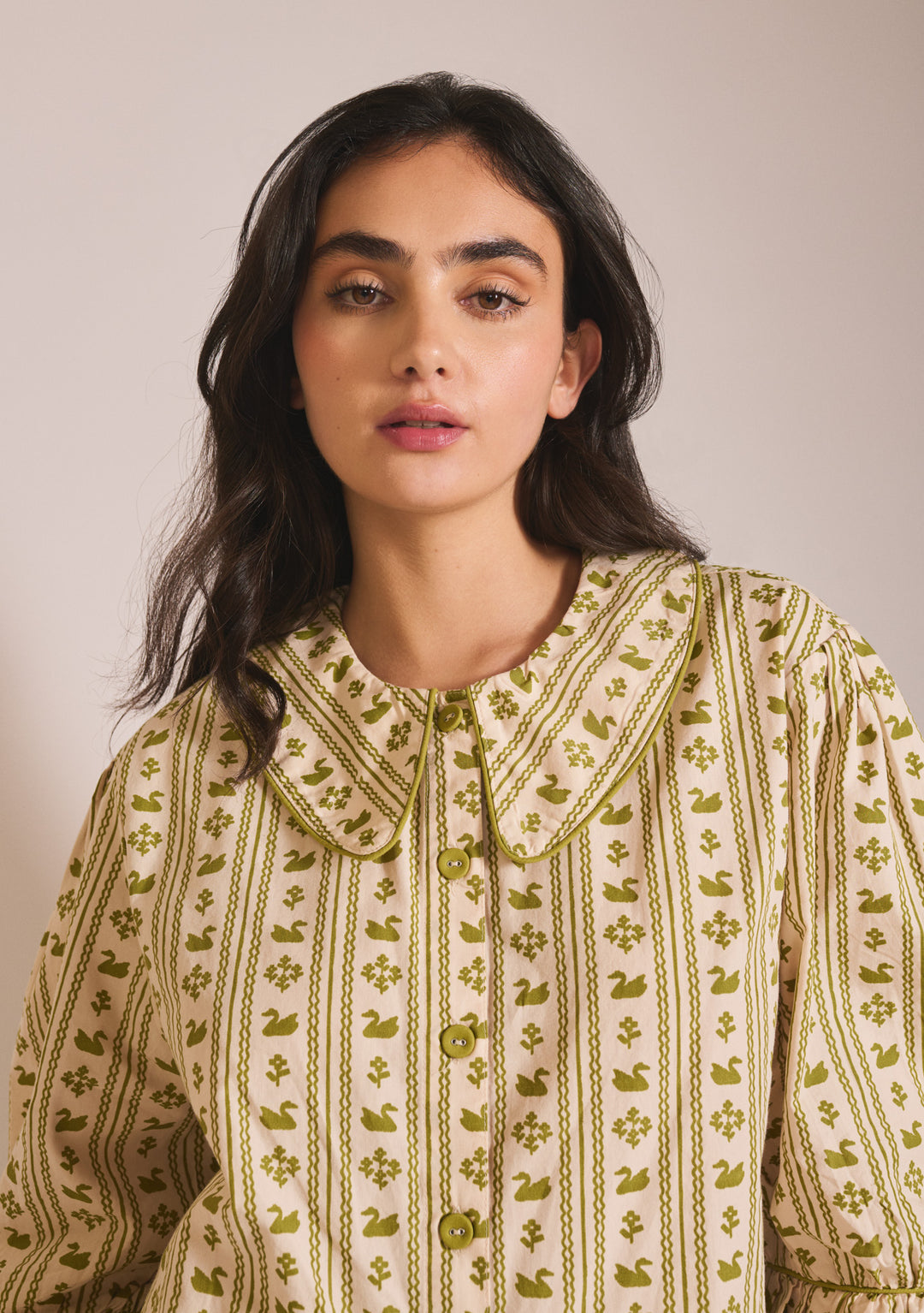 Model wearing TBCo Cropped Cotton Pyjamas in Olive Swan with detailed collar and button-front design on soft fabric