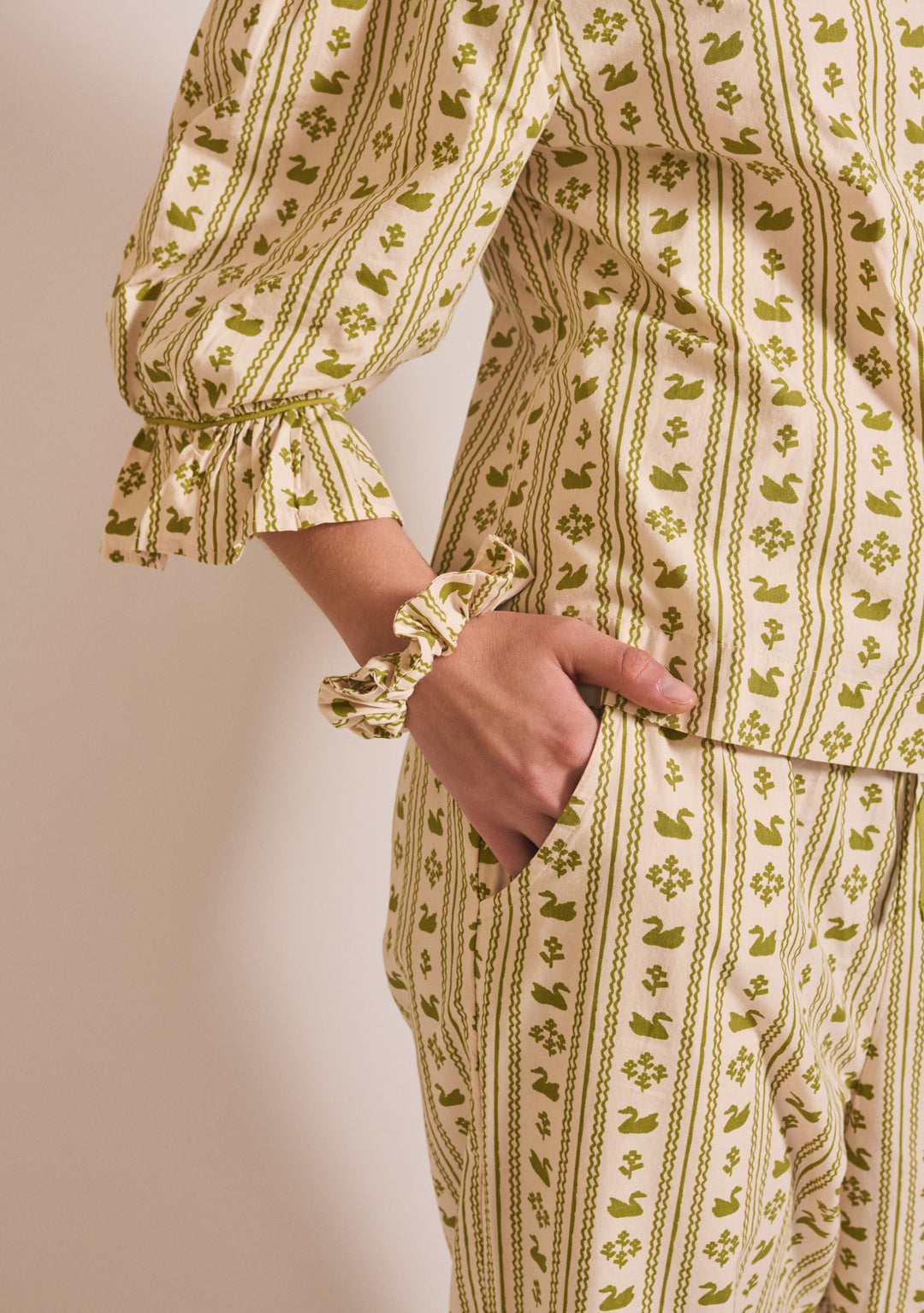 Close-up of TBCo Cropped Cotton Pyjamas in Olive Swan with gathered cuff and matching scrunchie on soft cotton fabric