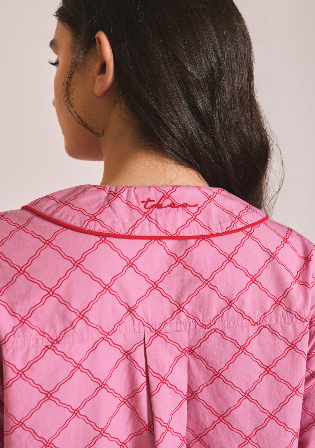 Back view of TBCo Cropped Cotton Pyjamas in Pink Lattice showing collar detail and embroidered logo in portrait orientation.