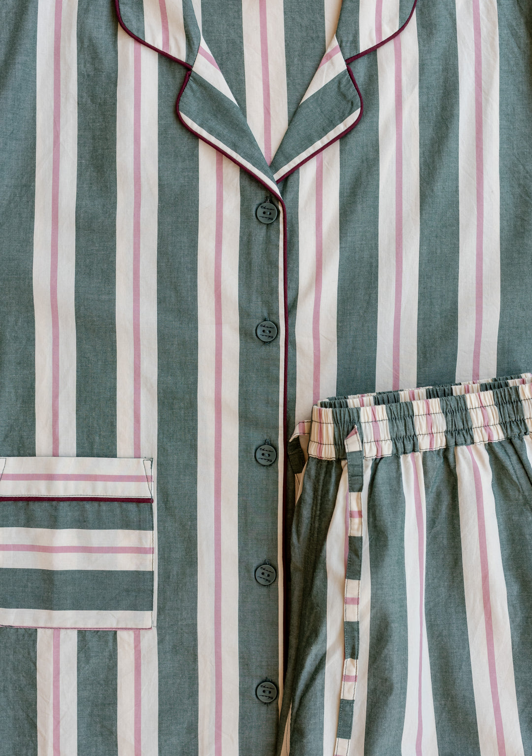 TBCo x Glassette Cotton Pyjamas in Green Stripe, featuring a button-down top with collar and piped trim, and elastic-waist bottoms, both with vertical stripes.