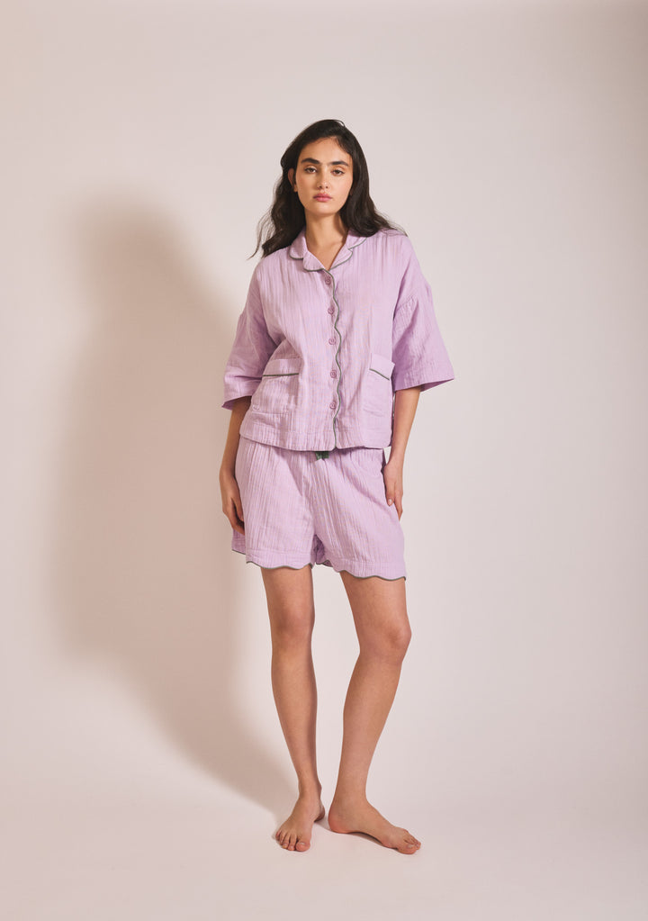 Model wearing TBCo Cotton Pyjamas in Lilac with green piping, gallery position 1, portrait orientation, 1442x2048.