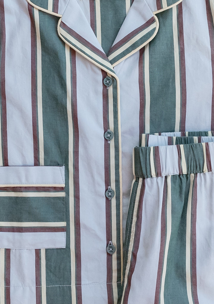 Close-up of TBCo Cotton Kids Pyjamas in Blue Stripe showing button front, collar, patch pocket, and elasticated waist detail